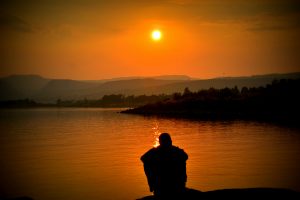Man sitting with the sunset